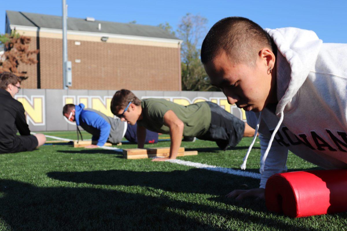 Rowan students do push-ups at the inaugural Fitness Festival. The event was held to promote exercise and to raise awareness of ALS. - Multimedia Editor / Dyone Payne