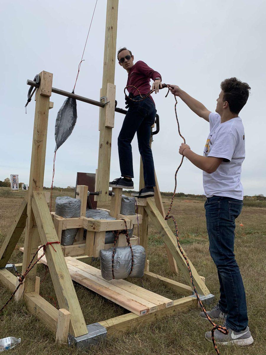 Junior mechanical engineering major Andrew Galloway makes adjustments to his team's trebuchet, while teammate freshman mechanical engineering major Anthony Romano assists. The Pumpkin Chunkin' event took place on Saturday, Oct. 26 at the South Jersey Tech Park. - Editor-in-Chief / Tara Lonsdorf