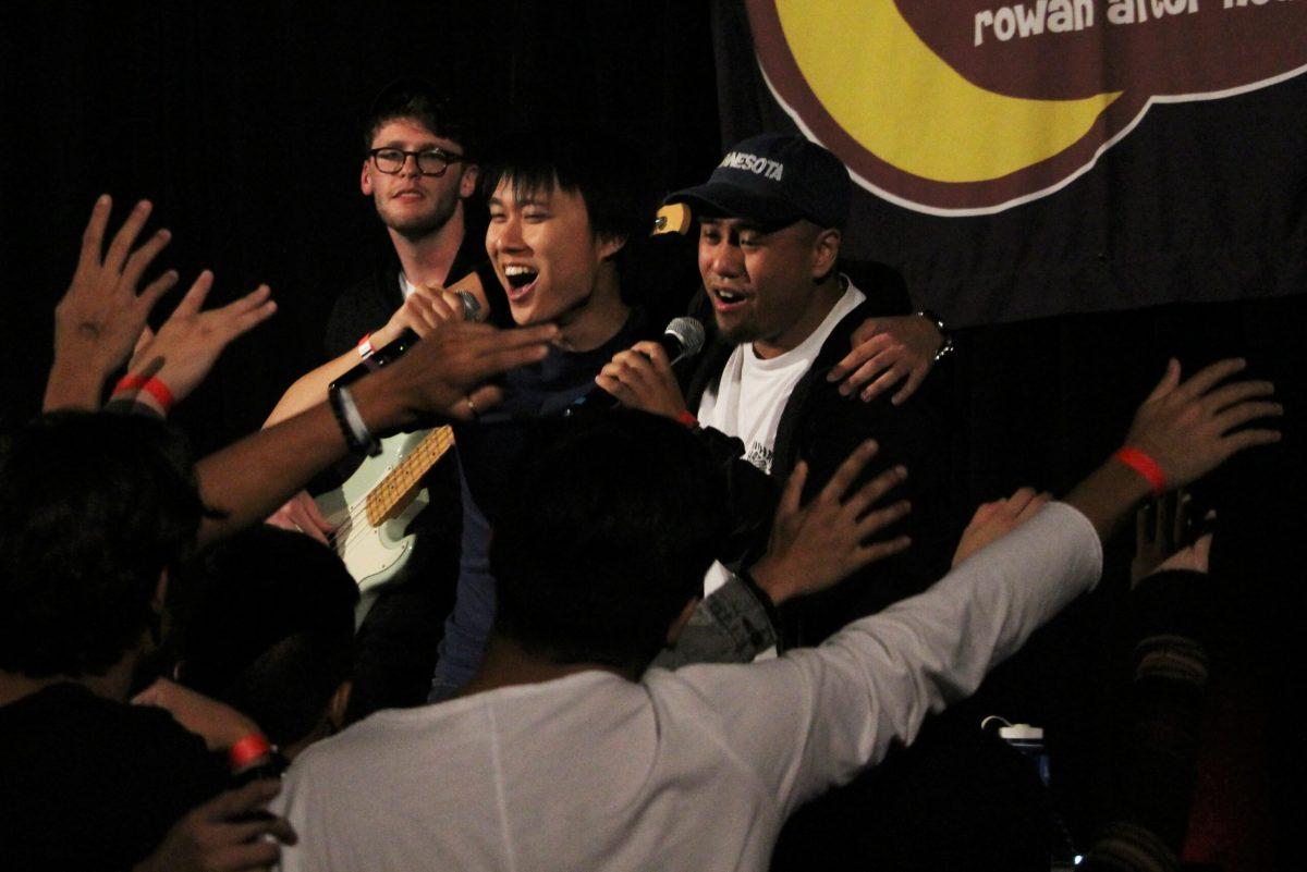 Matt Tam (middle) and Lucas Geniza (right) sing together as the crowd moves along to the music. This was one of several performances at the first-ever Filipino Heritage Festival. - Staff Writer / Kristin Guglietti