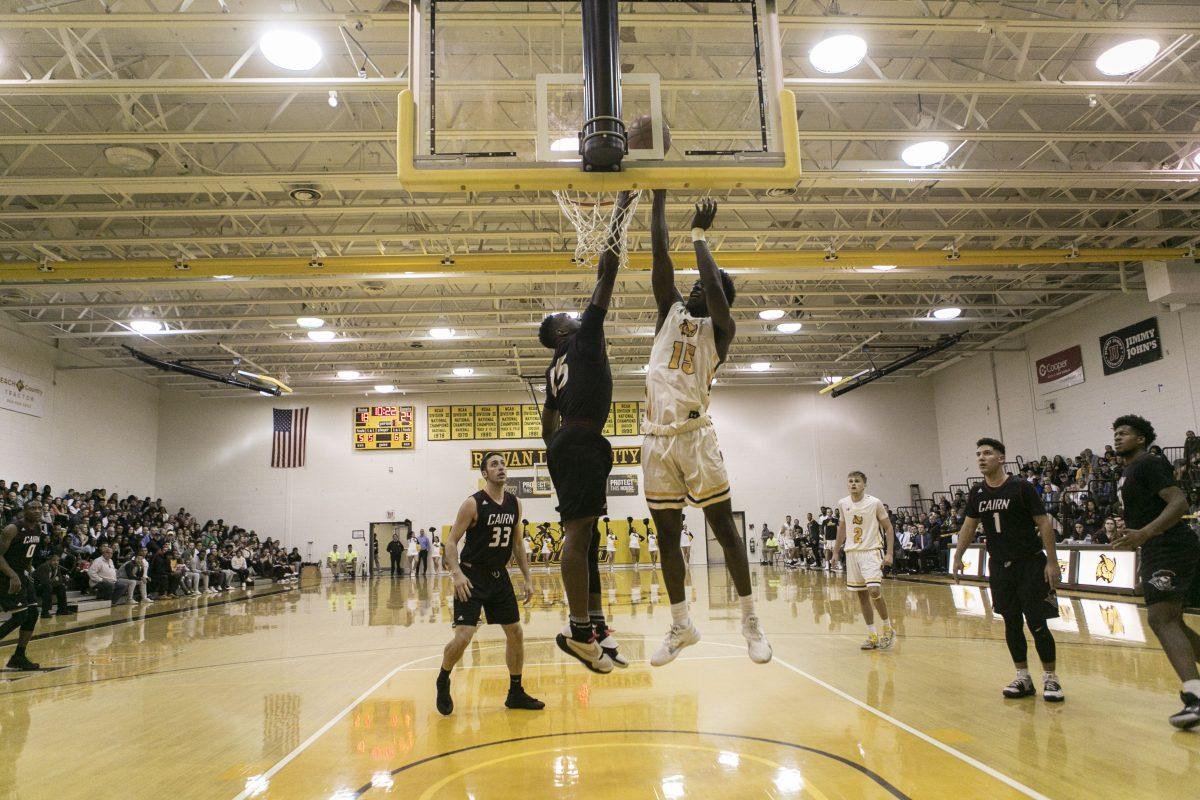 Jonathan Hevalow goes up for a dunk against a defender earlier this season. Photo/ Editor in Chief Miguel Martinez.