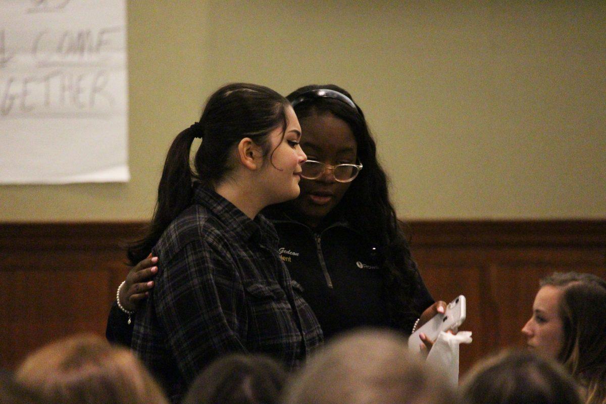 Emily DeSantos-Rademaker and SGA President Ariel Gideon hugged during the student discussion on December 9, 2019. - Photo / Staff writer Mike Reina