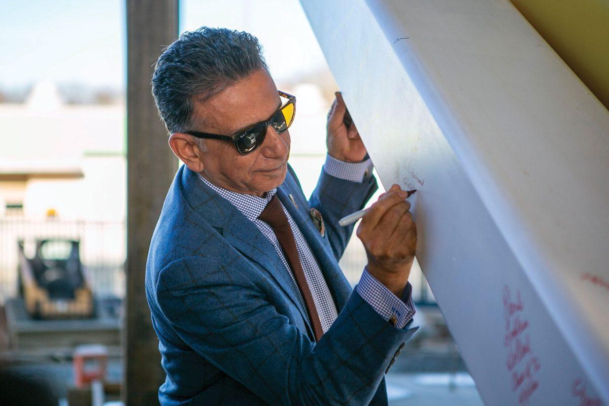 President Ali Houshmand signs a foundation beam in for the upcoming Discovery Hall building - Editor-In-Chief / Miguel Martinez