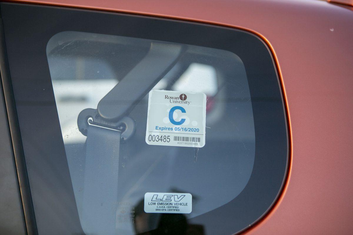 A commuter permit sticker is photographed in a car at a parking lot at Rowan's Glassboro Campus. Editor-in-Chief / Miguel Martinez