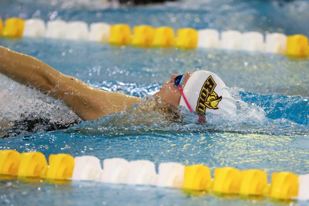 Abigail Brous swims back stroke in a meet this year. Photo/ Rowan Athletics.