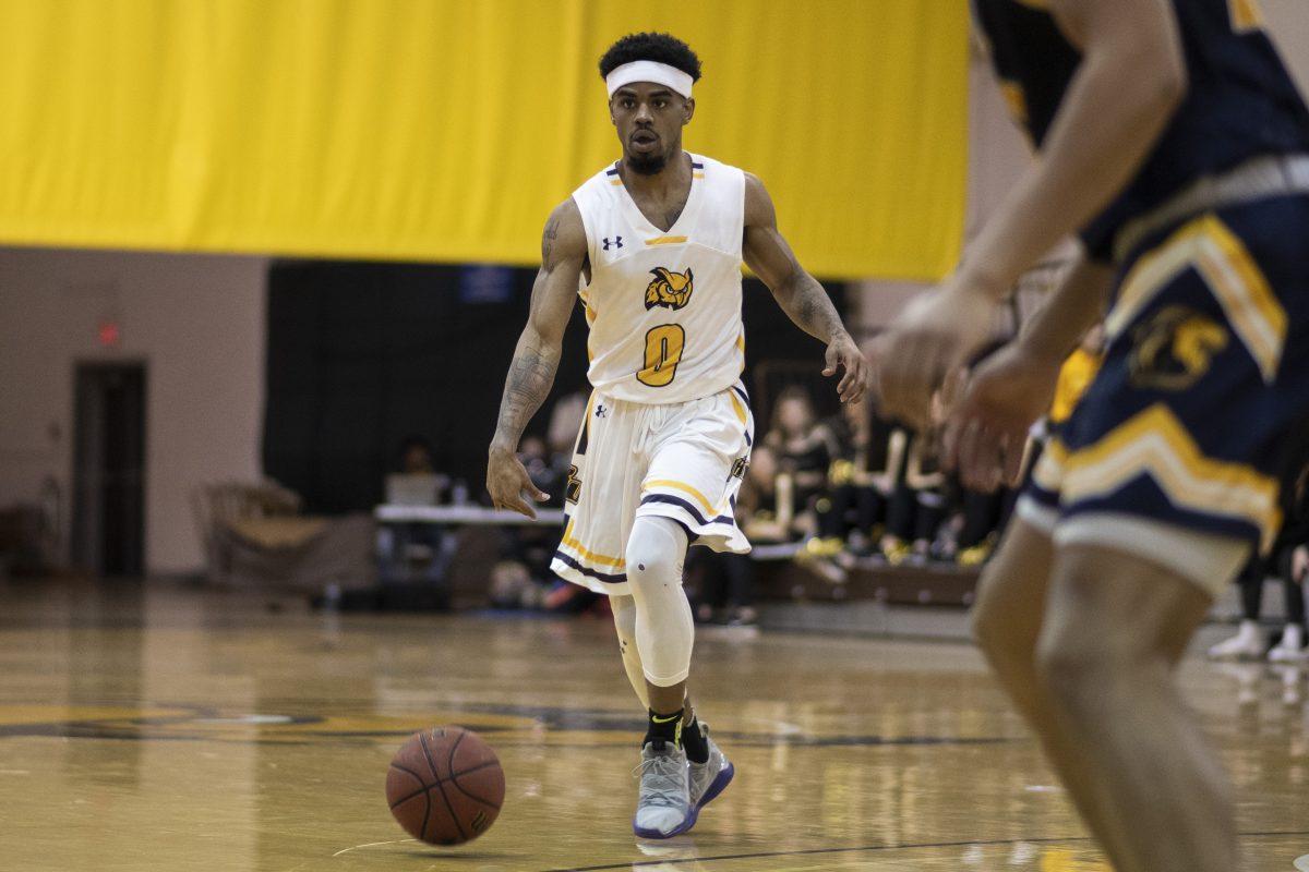 Jerry Price handles the ball against TCNJ. Price led the team with eight assists in the game. Wednesday, Jan. 29, 2020. Staff Photographer / Ben Stephens. 