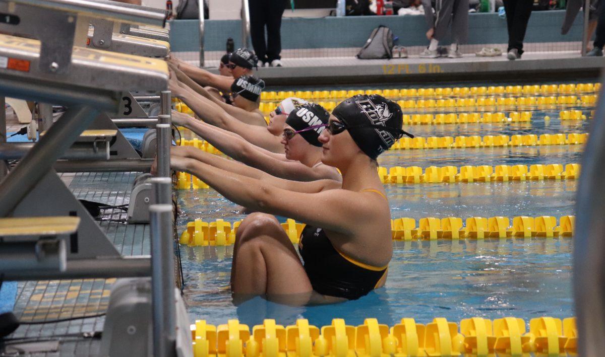 Rowan women's swimming gets ready to swim backstroke against USMMA. Saturday, Feb. 1, 2020. Multimedia Editor / Dyone Payne.