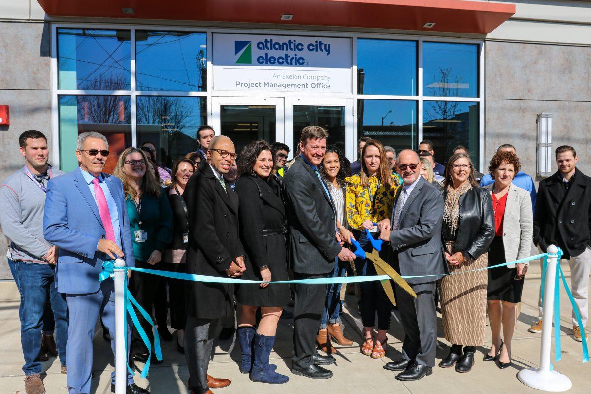 Dan Loveland (Left Center), Justine Kozlowski (Center) and Gary Stockbridge (Right Center) hold the ceremonial scissors before officially cutting the ribbon for the new Atlantic City Electric office at 211 High St. West. on Friday, Feb. 21, 2020. Staff photographer / Vincent Rebbecchi.