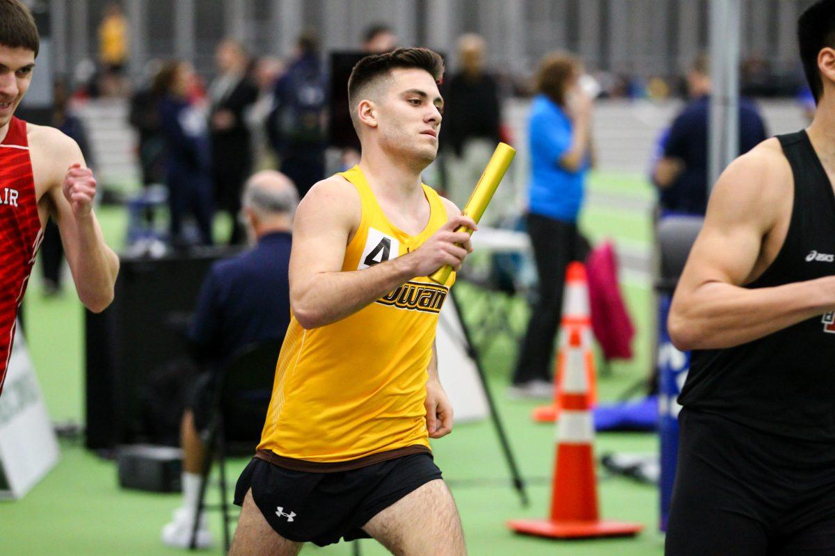 Mitchel Baron runs in a relay. Photo/ Rowan Athletics.