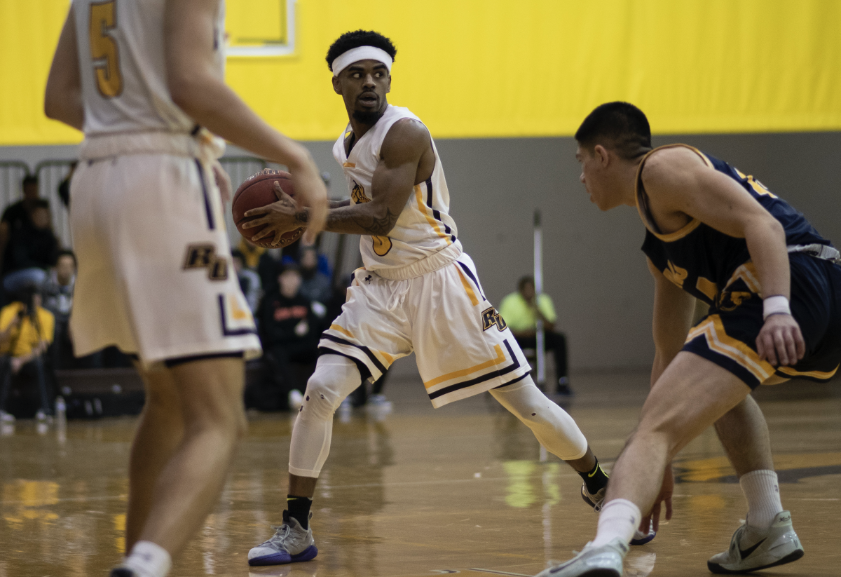 Jerry Price (center) looks for a passing option against TCNJ. Price was named NJAC athlete of the week for men's basketball. Wednesday Jan. 29, 2020. Ben Stephens/ Staff Photographer.