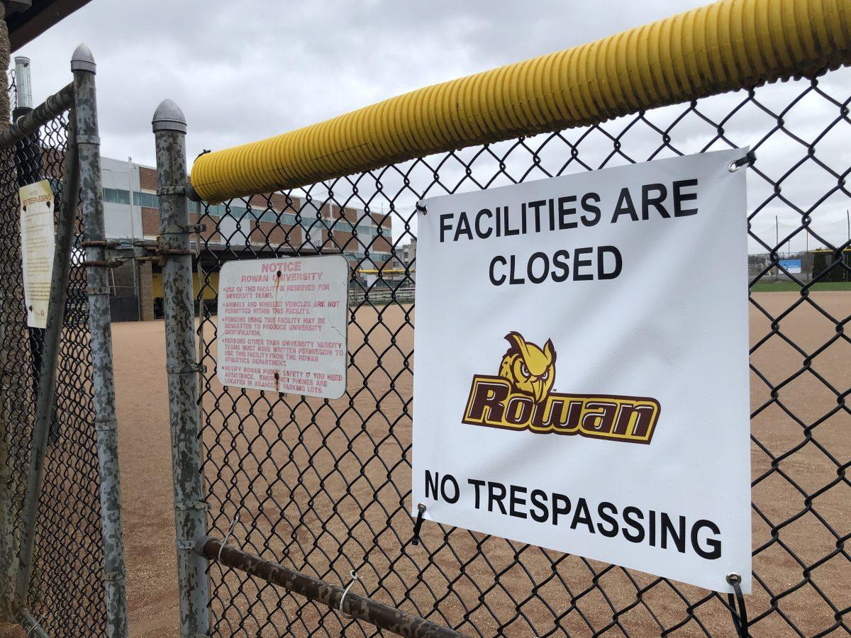 A sign on a fence saying that fields are closed at Rowan University. - Editor-in-Chief / Miguel Martinez.