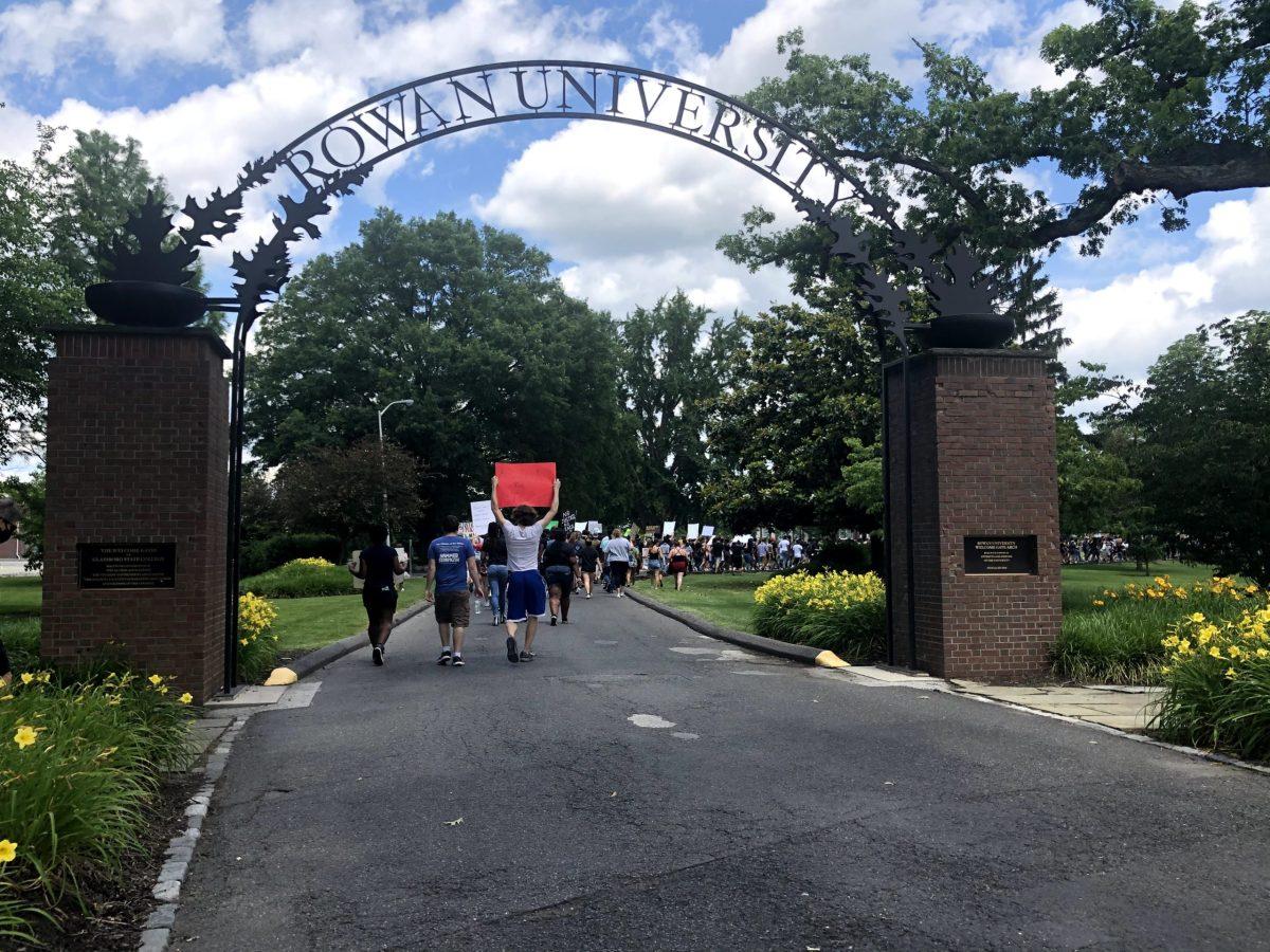 People walk through the Rowan arch on the road to Bunce Green during the BSU protest. - Editor-in-Chief / Kalie VanDewater