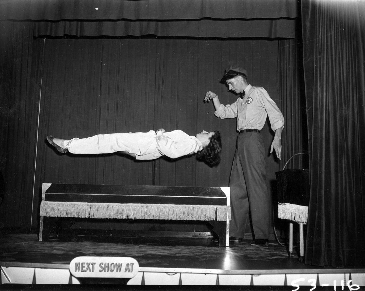 1953 magician wows audiences by making a woman levitate during Esso Magic Show. - Photo via Vancouver Archives