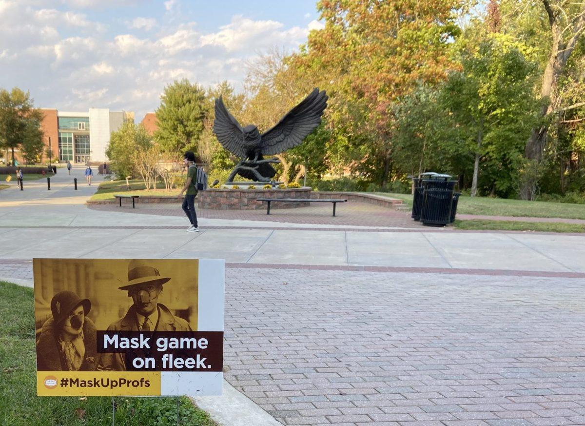 One of Rowan's #MaskUpProfs signs in front of the Rowan Prof statue. It is important to take precautions, such as getting a flu vaccine, to reduce overcrowding in hospitals. - Multimedia Editor/ Alexander Rossen