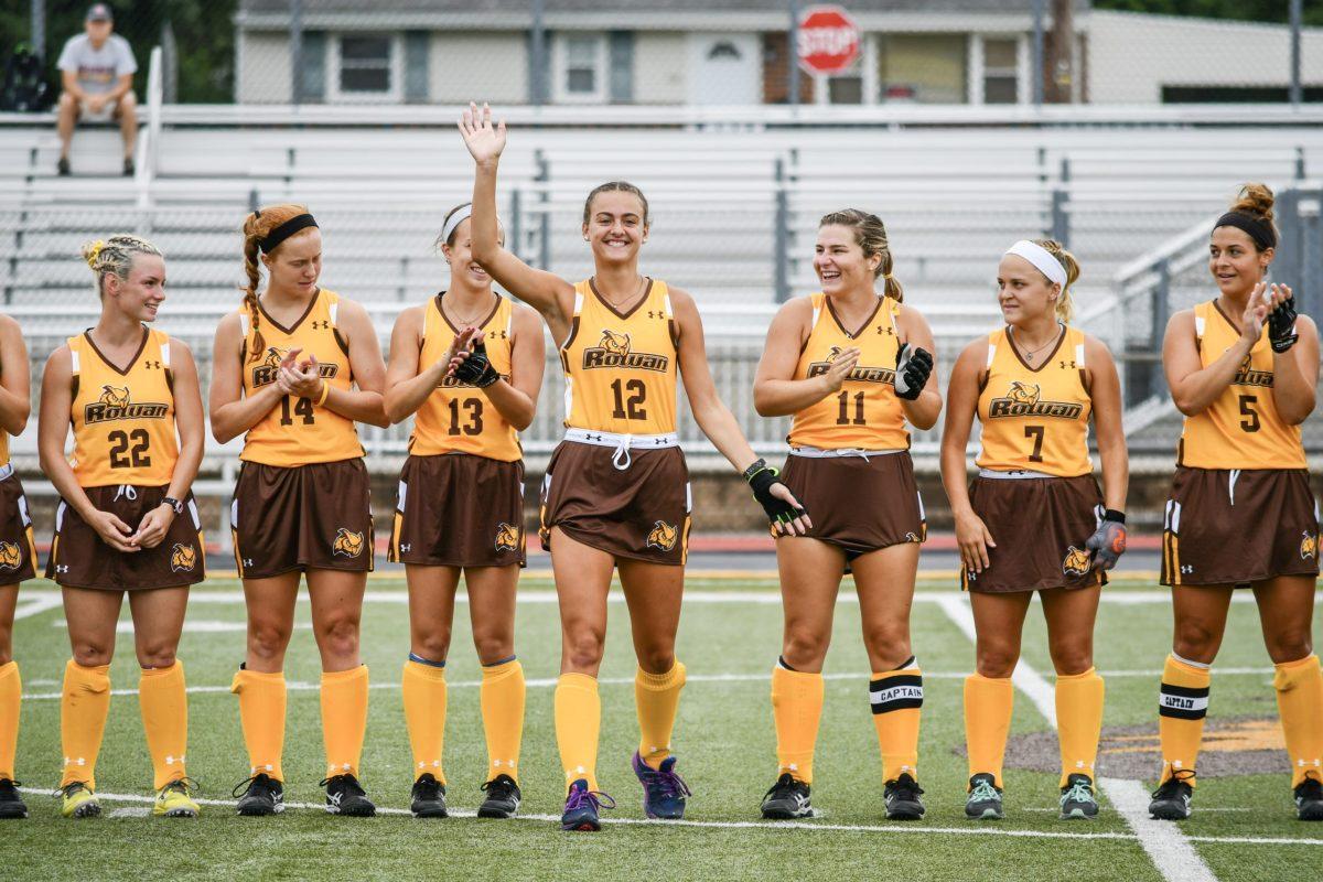 Molly Gorczyca waves to the crowd with support from her Rowan Field Hockey teammates. - Photo courtesy of Molly Gorczyca