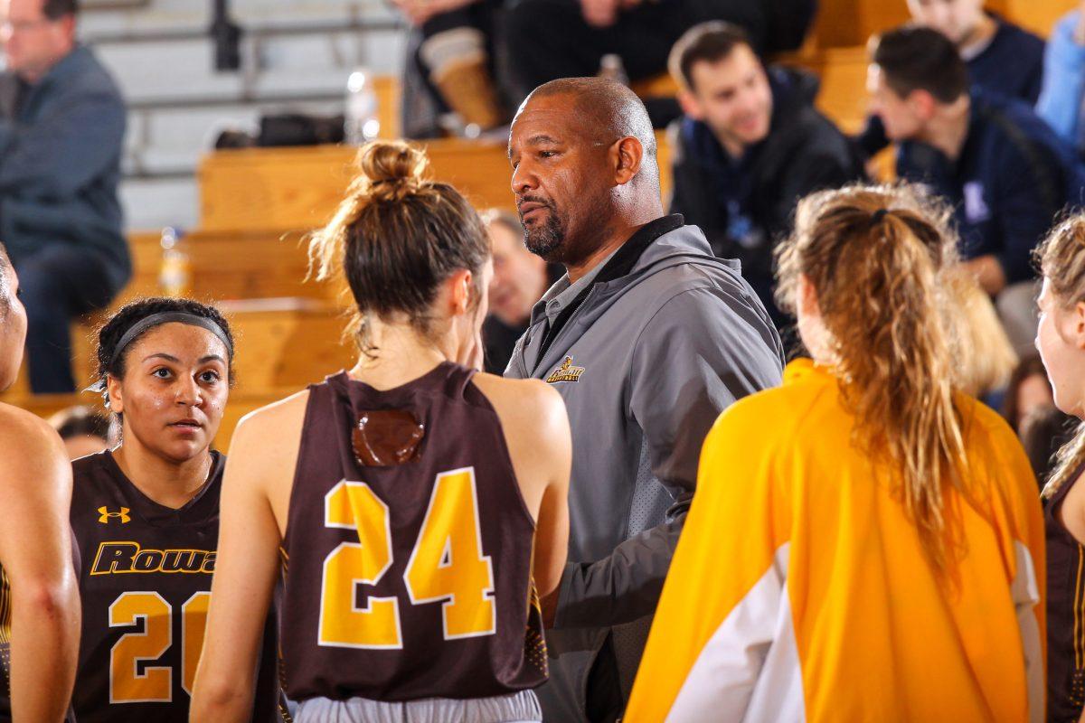 Head Coach Demetrius Poles in a huddle with the team last season. The team has resumed practicing in preparation for next season. - Photo / Rowan Athletics 