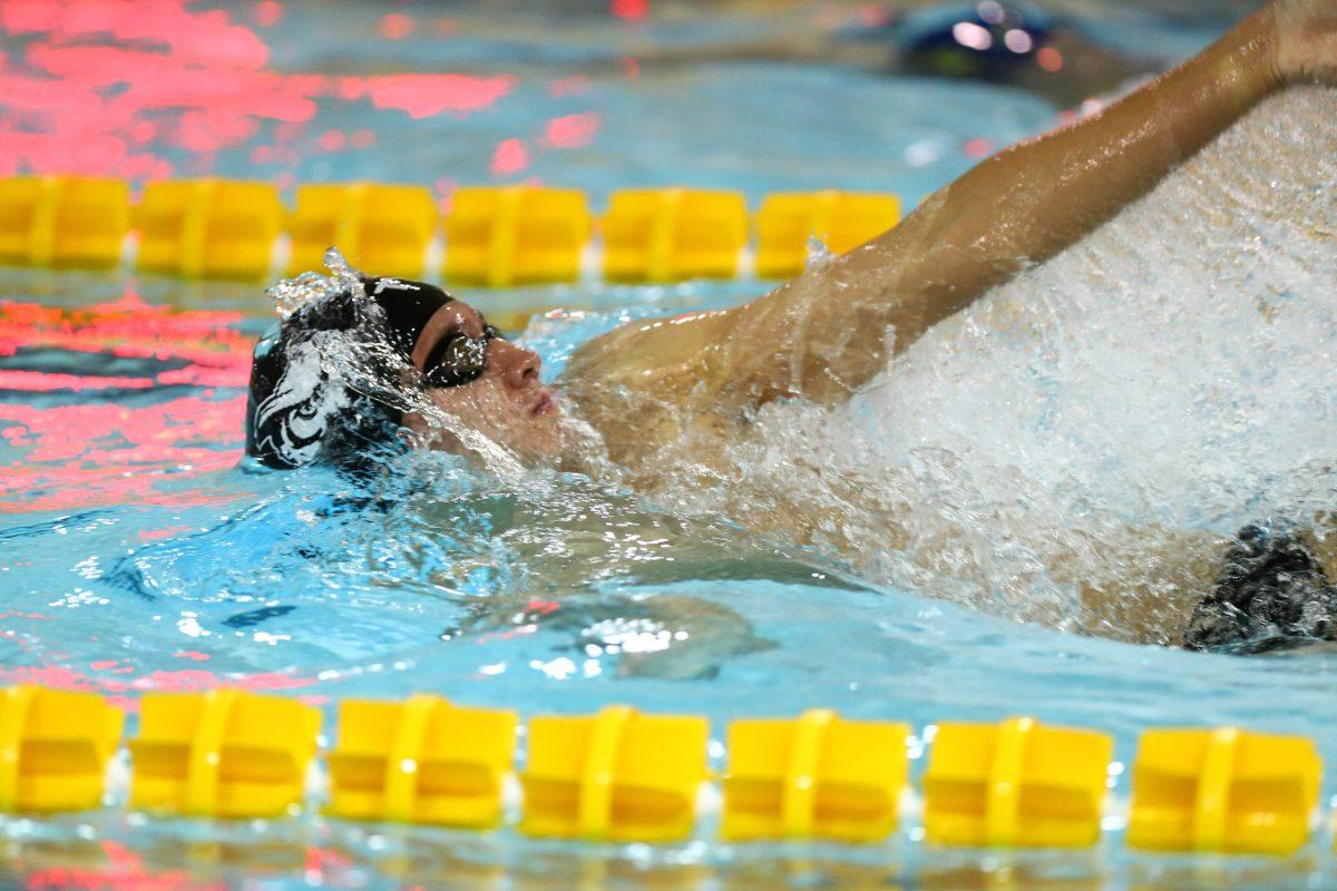 Swimmer Kevin Gillooly during a backstroke race. Gillooly and his teammates' season has been postponed due to COVID-19 concerns. - Photo via Rowan Athletics 