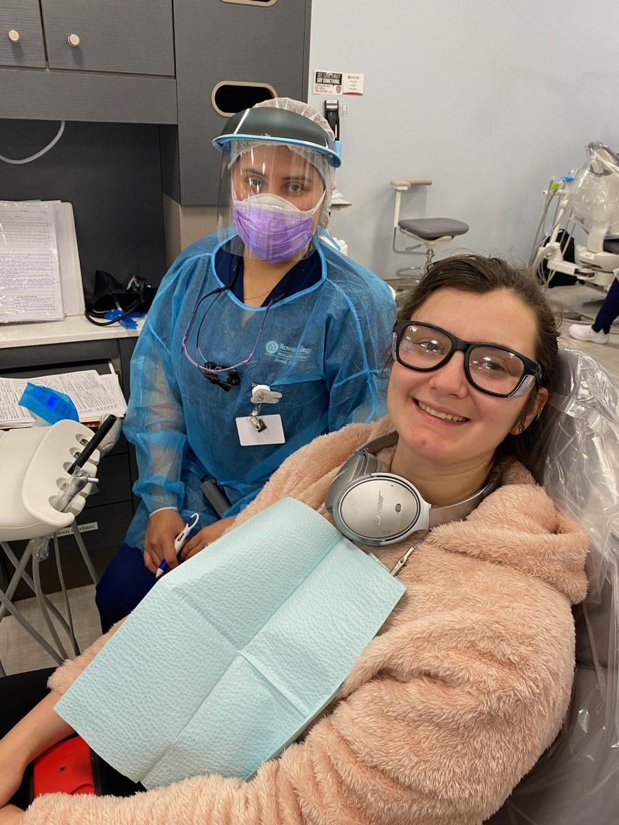 RCBC dental hygienist, Estafany, poses with Tara Lonsdorf before her cleaning and examination. Both are Rowan students: Lonsdorf an undergrad in geology, Estefany training to be a dental hygienist. - Photo by RCBC Dental Hygiene Clinic receptionist / Mary Kay 