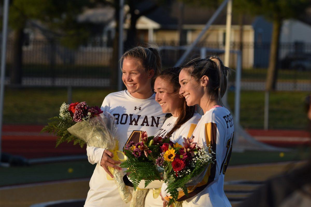 Seniors [left to right] Dara Hennessy, Ashley Lechliter and Julia Grlica being honored before their game against Stockton on March 30. This was a part of their "Senior Day" ceremony. - Staff Photographer / Nicholas Feldman