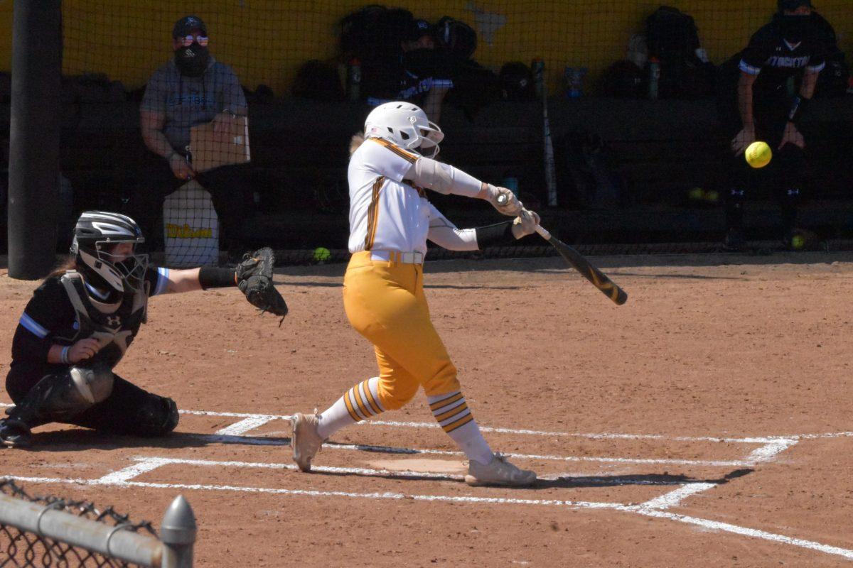 Sophomore infielder Breanna Bryant hits the ball during a game against Stockton on March 27. In the past doubleheader against Stockton, Bryant recorded four hits and two RBIs. - Staff Photographer / Nicholas Feldman