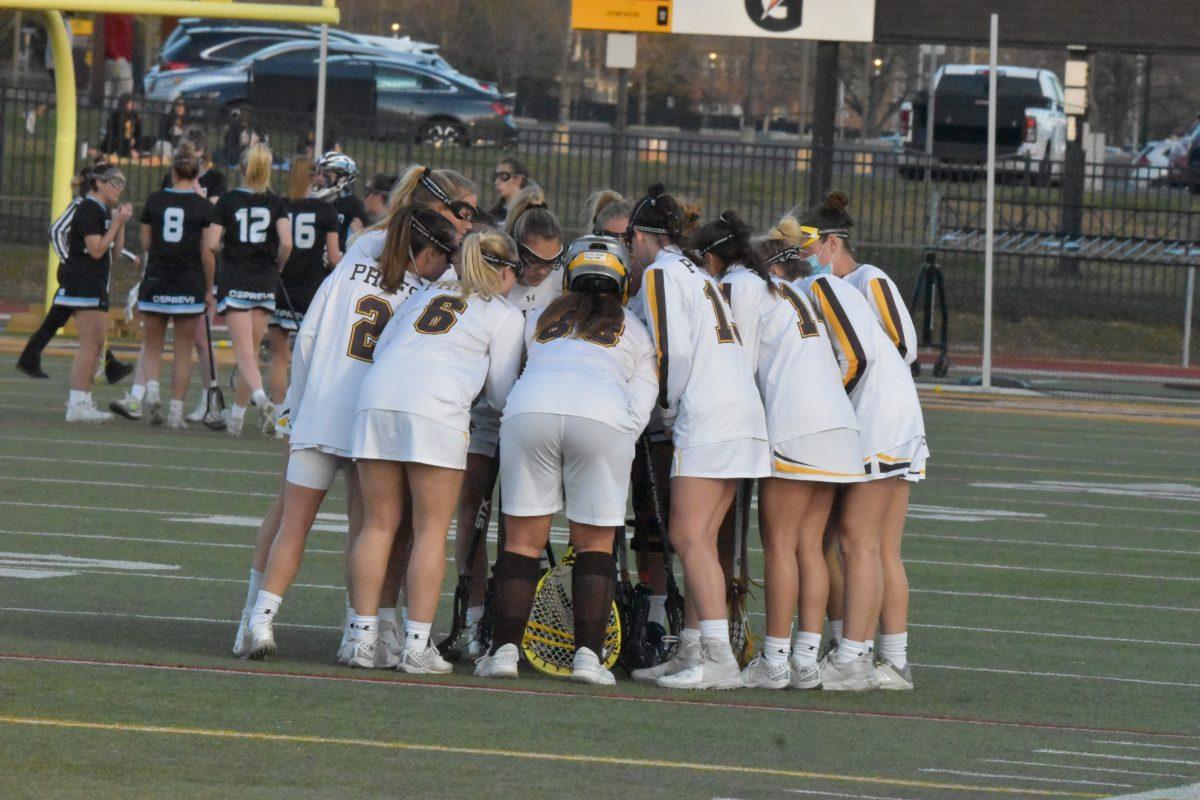 The Rowan lacrosse team stands in a huddle before their game against Stockton University on March 30. They recently lost their game against TCNJ 11-22 on April 10. - Staff Photographer / Nicholas Feldman