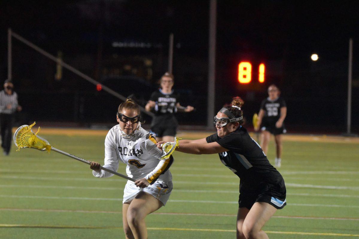 Rowan lacrosse's Jamie Cutrera goes against a defender in their game versus Stockton on March 30. Cutrera scored her first two goals of the season during Rowan's victory against Kean this past Saturday. - Staff Photographer / Nicholas Feldman