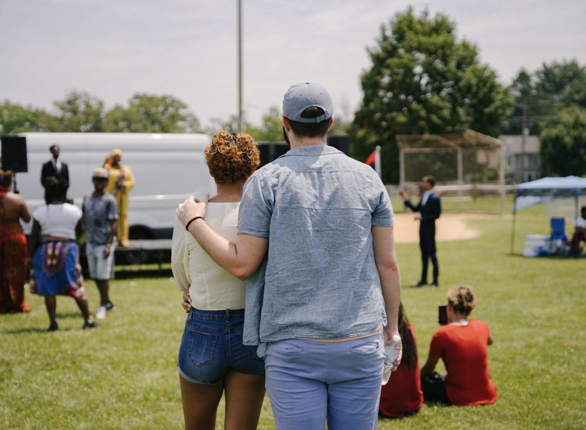 A young couple listens to the Juneteenth keynote speech, given by guest speaker Nurah Muhammad. Photo via staff photographer/Nathan Morris