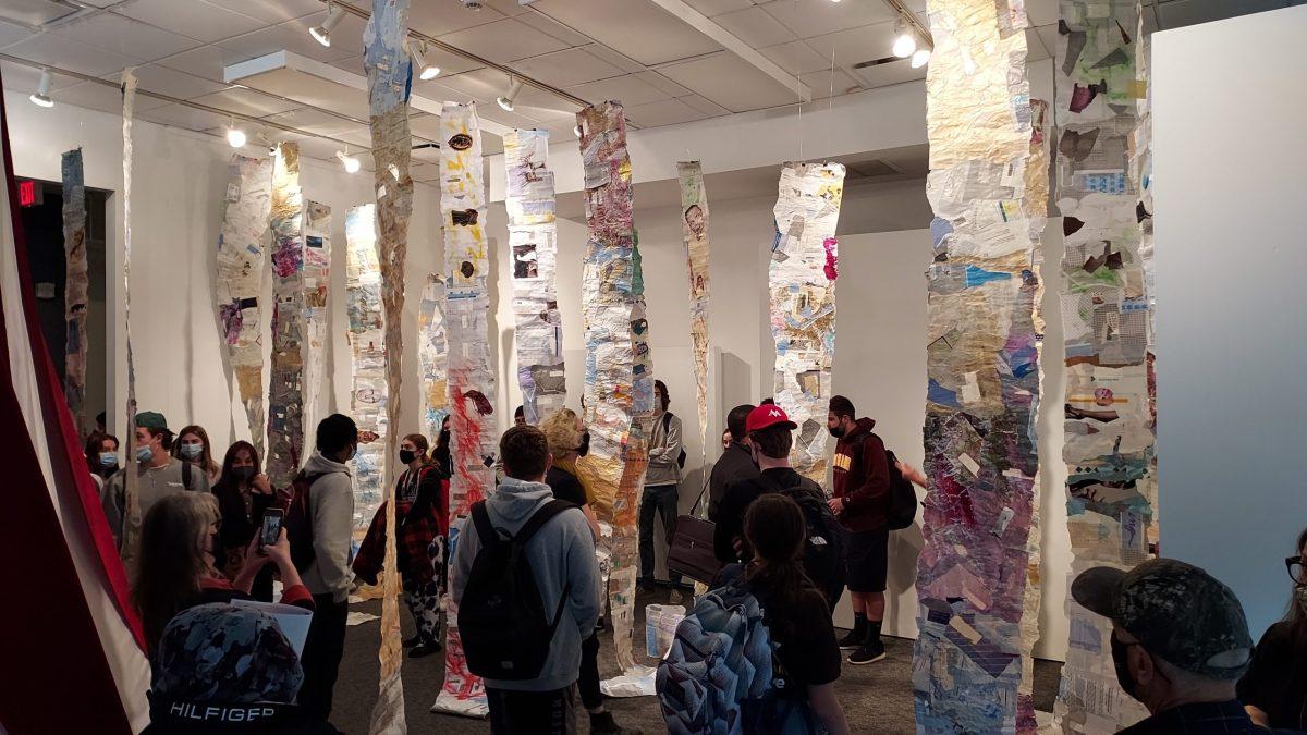 Over twenty students filled the exhibit space on Oct. 28 to listen to the artist explain her process and mission for this piece. Staff Writer / Chelsea Valcourt 