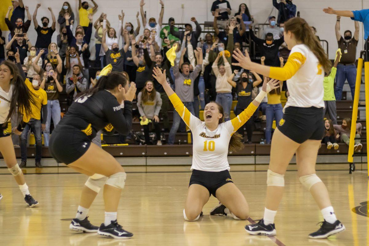 Left to right: Rowan's Simone Sparano, Natalie Ogden, and Brooke Adams celebrating after their Championship winning point. Rowan would defeat Montclair State in the NJAC Championship match 3-2. Saturday, Nov. 6, 2021. - Staff Photographer / Lee Kotzen