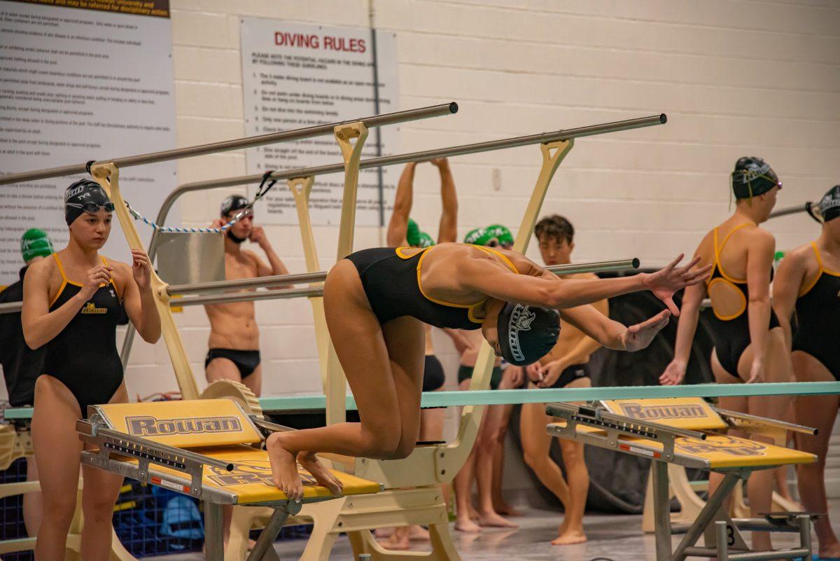 A Rowan swimmer diving into the pool. Rowan's women's diving competed in their first invitational this past weekend. Saturday, Oct. 23, 2021. - Multimedia Editor / Nick Feldman