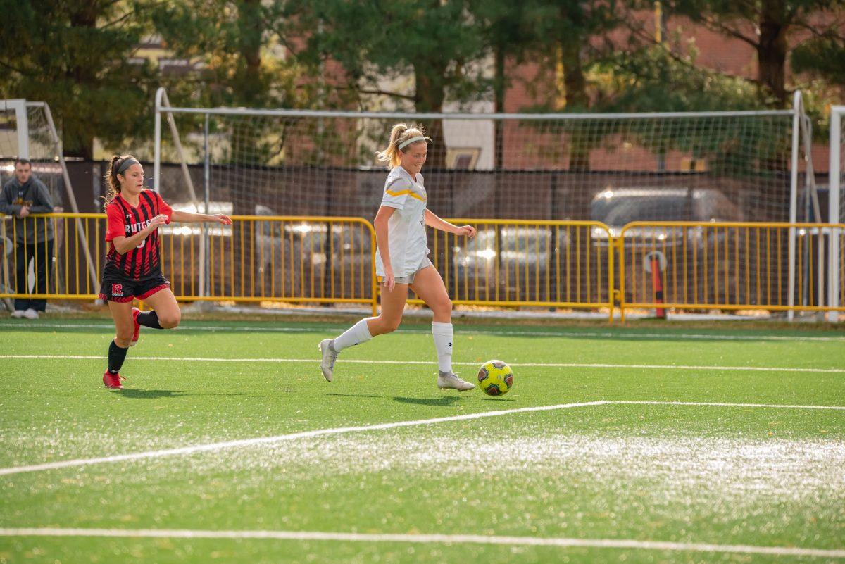 Rowan's Aidan Sheehan dribbling up the field ahead of a defender in their game against Rutgers-Camden. Sheehan would score the first and only goal in this NJAC Playoff game in which Rowan won 1-0. October 30, 2021.  - Multimedia Editor / Nick Feldman