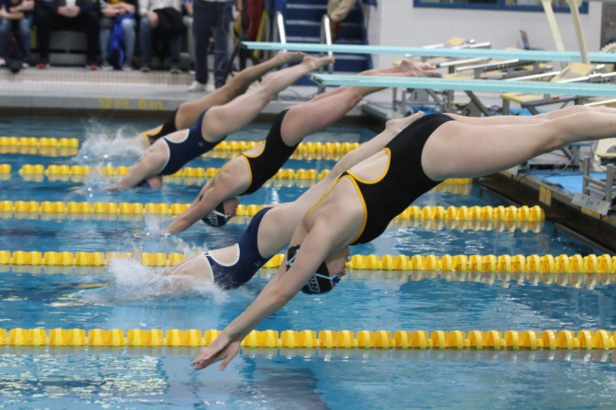 Both Rowan and TCNJ swimmers diving in at the beginning of a race. Rowan would defeat TCNJ on Saturday to win the NJAC Championship. Saturday, Jan. 22, 2022. - Multimedia Editor / Lee Kotzen 