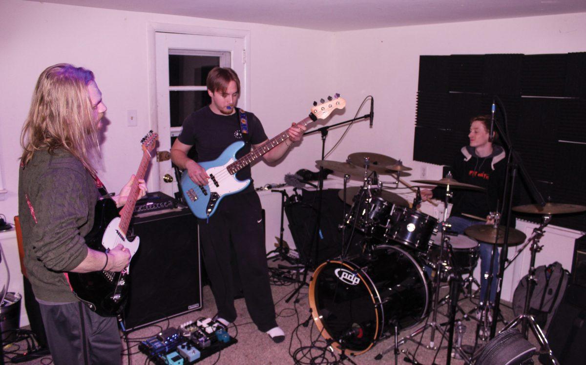 Pictured left to right: Eddie Masterson, Bryce Mirabella and Ryan DeCesare rehearsing in their house. / Copyeditor Berry Andres