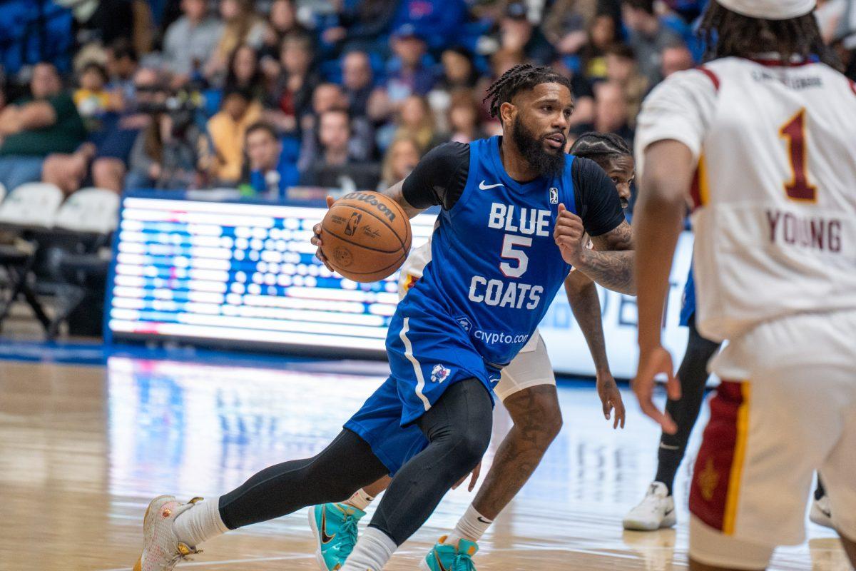 Myles Powell driving to the basket against the Cleveland Charge on Friday night. Powell led the way for the Blue Coats with 26 points in their win. Friday, March 25, 2022. - Staff Photographer / Joey Nicolo