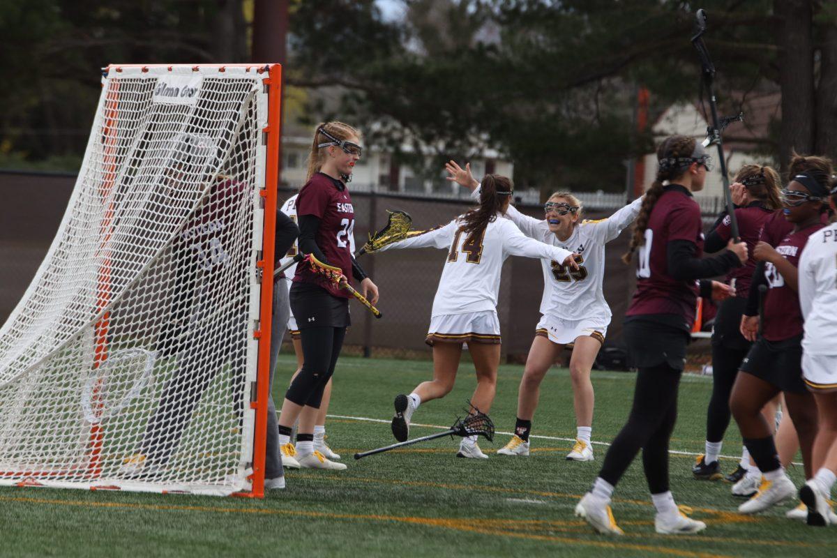 Sophia Schiavo and Shannen Sterner celebrating after a goal against Eastern University. Rowan picked up the 21-2 victory that afternoon. Saturday, March 26. - Multimedia Editor / Lee Kotzen