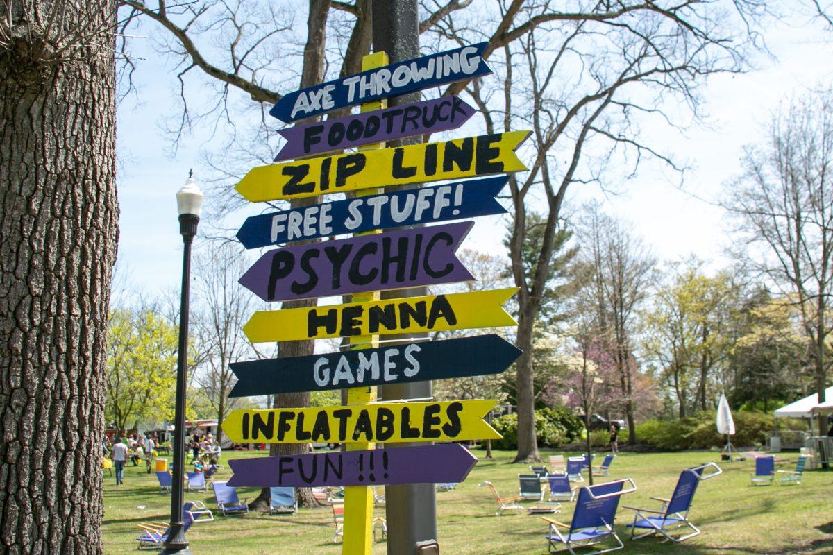 Sign post pointing to Holly Bash's various activities. / Photo via Sam Laflamme