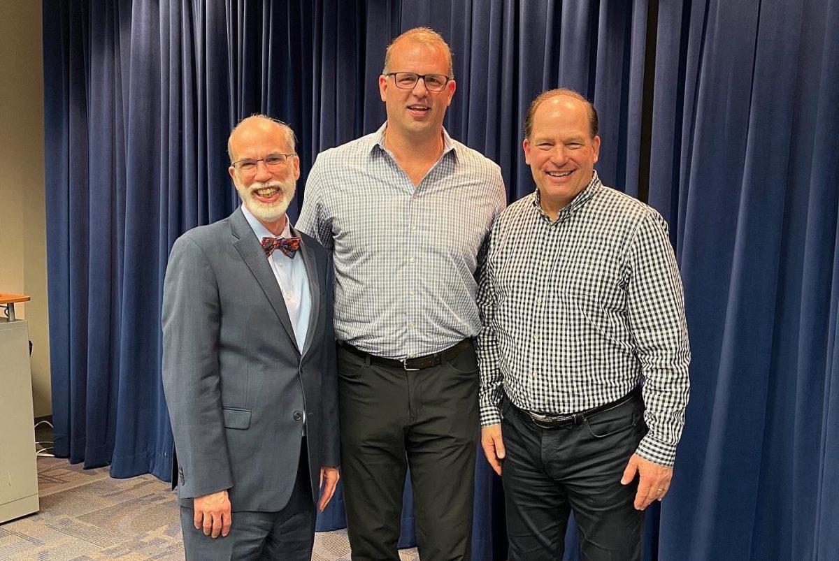 Rowan College of Communication and Creative Arts Dean Tweedie, former Eagles lineman John Runyan and Director of Sports Communication Neil Hartman pose for a photo during "Pizza With the Pros." Runyan discussed his career with the Eagles, as the VP of NFL Rules and his political career during this week's discussion. - Photo via @RowanSportsCAM on Twitter.com