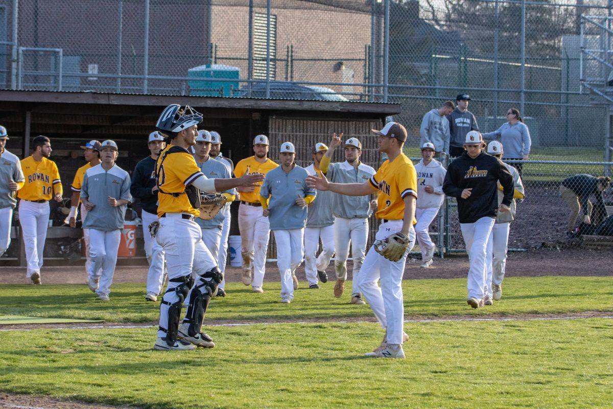 Hunter Wroniuk, Mike Shannon, and the rest of the team celebrate a win earlier in the season. Both played a key role in their Regional Championship win. Tuesday, March 22, 2022. - Multimedia Editor / Lee Kotzen