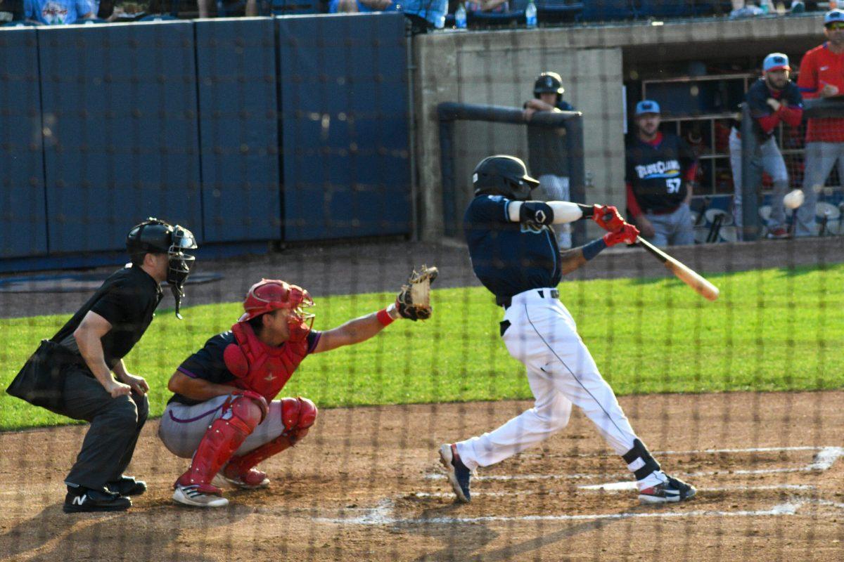 Darren Baker swings at a pitch. Baker and the Blue Rock struggled to capitalize with runners in scoring in their loss Friday night. Friday, July 1, 2022. - Staff Photographer / Tyrese Williams