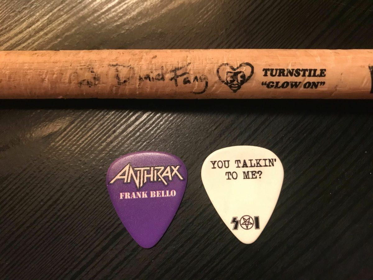 Amber's souvenirs from summer concerts include a drumstick signed by Daniel Fang, and guitar picks from Frank Bello and Scott Ian. / Photo via Amber Bertino