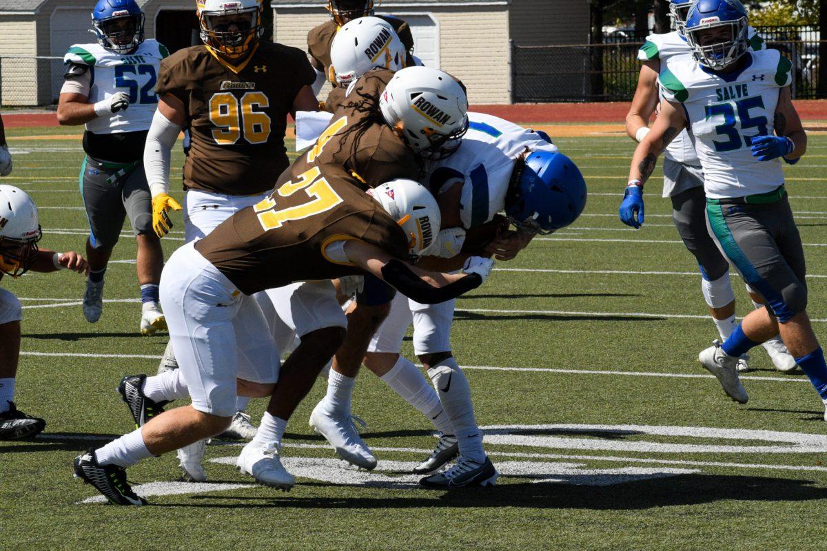 Rowan defenders bring down a Salve Regina player. Rowan dropped their first game of the season to Salve Regina. Saturday, Sept. 24, 2022. - Staff Photographer / Tyrese Williams