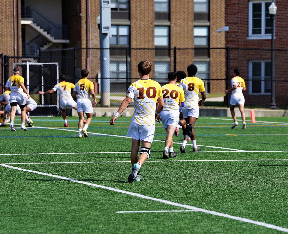 Some of Rowan's men's rugby team watches the end of a play. Men's rugby is set to open their season this upcoming weekend. Saturday, October 2, 2021. - Staff Photographer / Ashley Craven