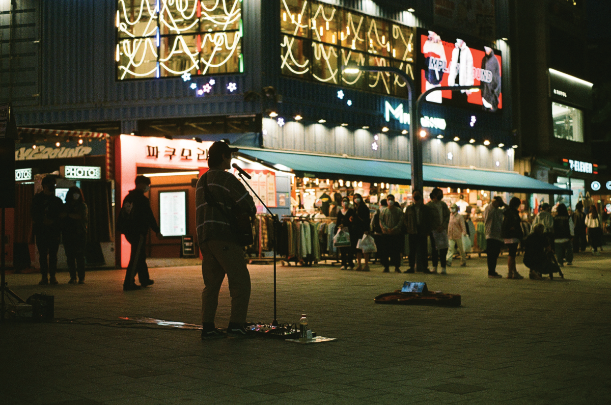 A street artist performs for a busy street in Hongdae, a neighborhood in Seoul, South Korea. / Photo via Marissa Pavorsky