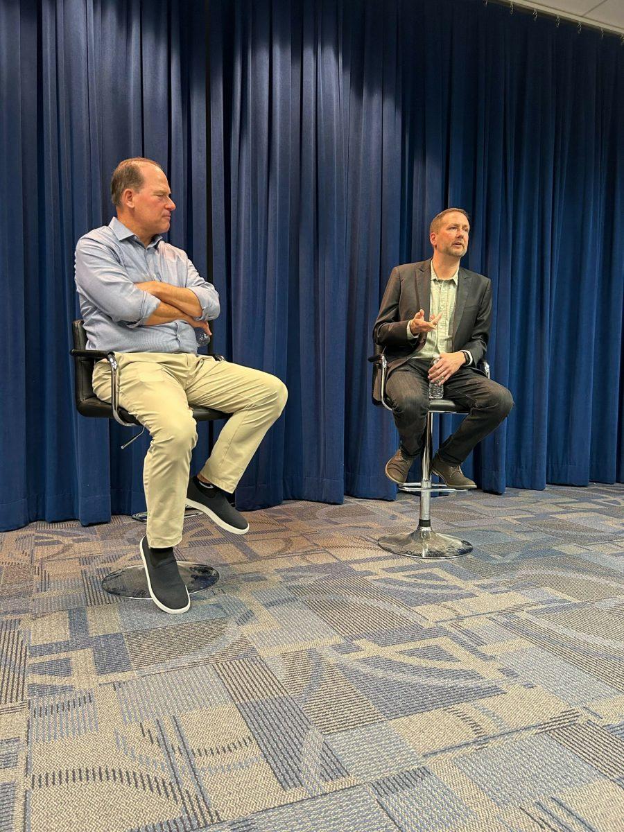 Rowan Sports Communications Director Neil Hartman  listening to NHL VP of Game Presentation John Bachiaro. Photo via @RowanSportsCAM on Twitter.com 