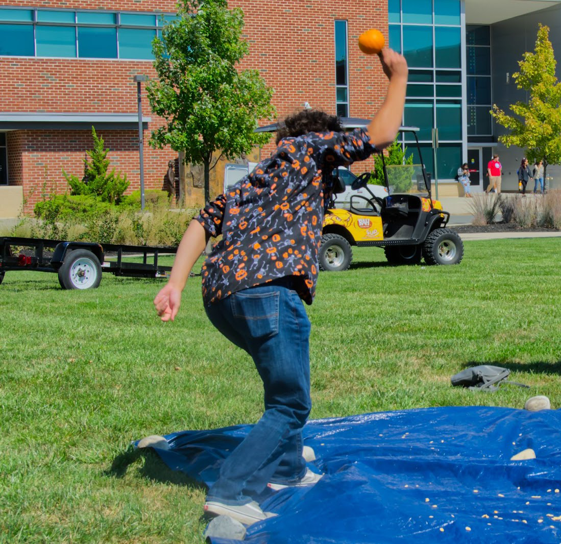 Juniors smash pumpkins together to relieve stress for the semester ahead. - Photo / Adriana Zawojski