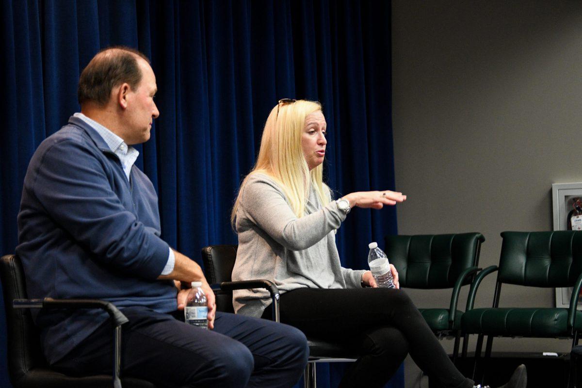 Rhea Hughes speaking to students next to Rowan Sports Communication Director Neil Hartman. - Staff Photographer / Tyrese Williams