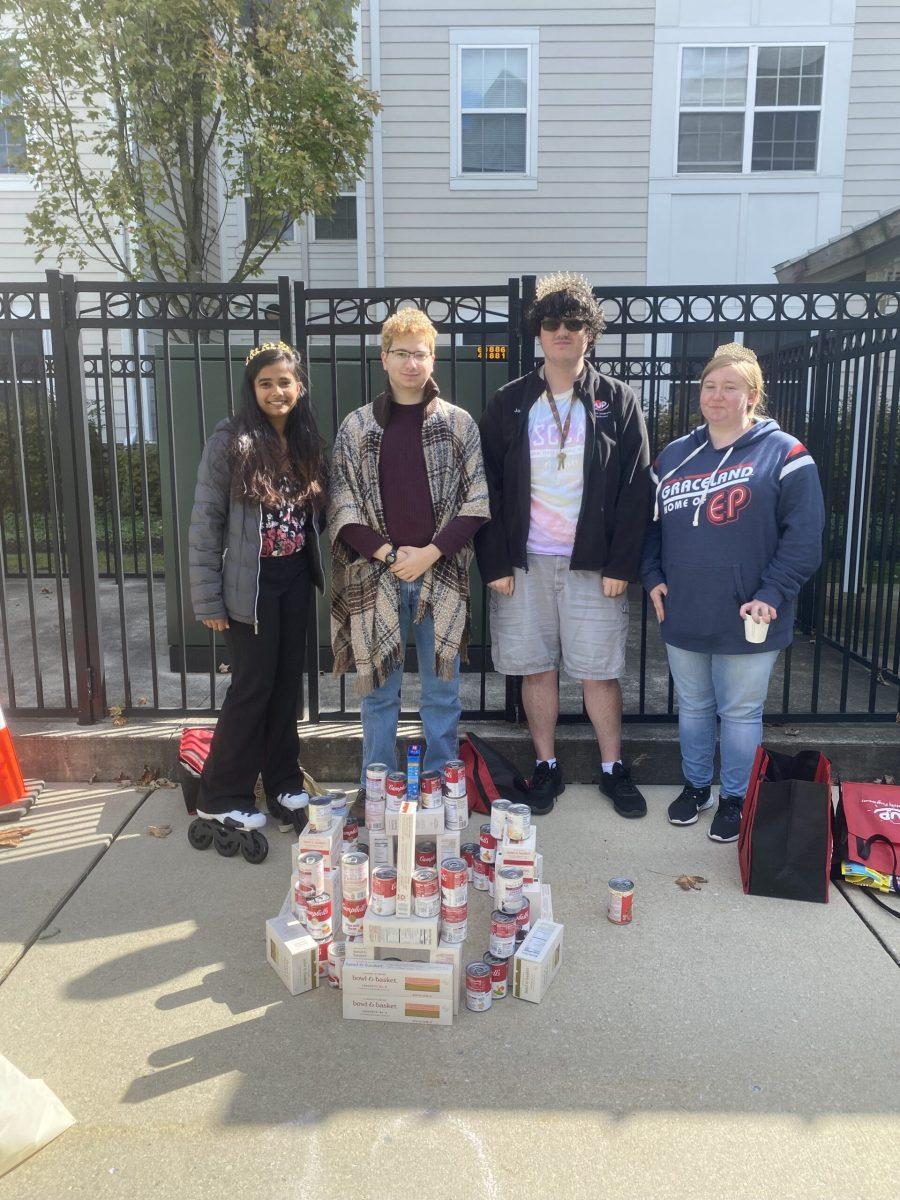 Theta Phi Alpha x Theta Chi members stand by their CANstruction. -Contributor / Connor Brown