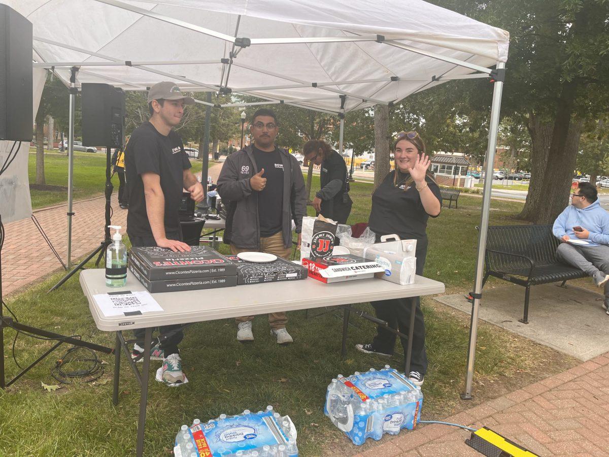 Members of RTN hand out free pizza and drinks to "Back to Boz" guests. - Staff Writer / Kariyah Bennett