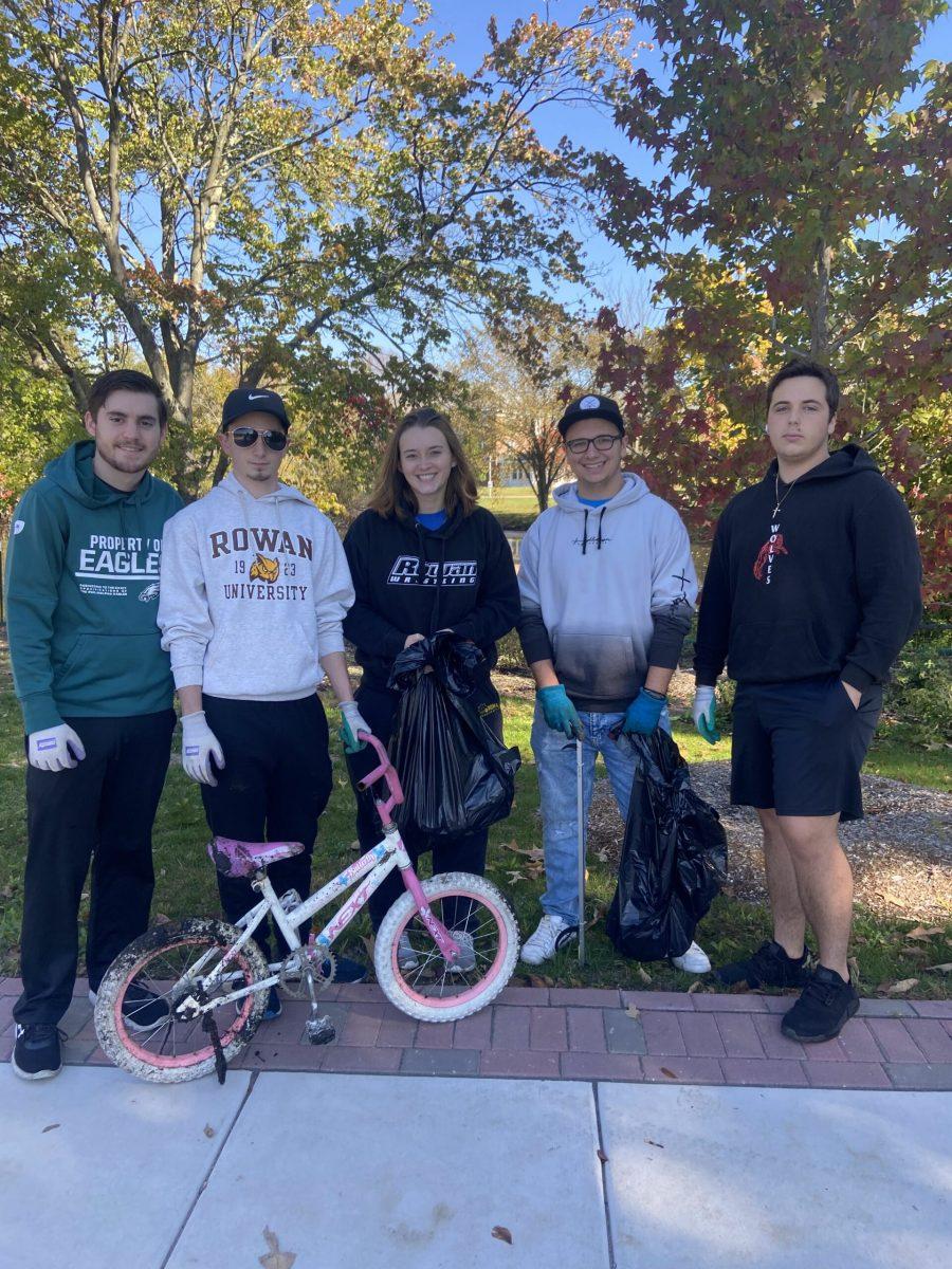 Tyler Spires, Mike Padula, Kayla King, Will Karaces and Joey Gargione stand with a recovered bicycle. - Staff Writer / Elena Laughton
