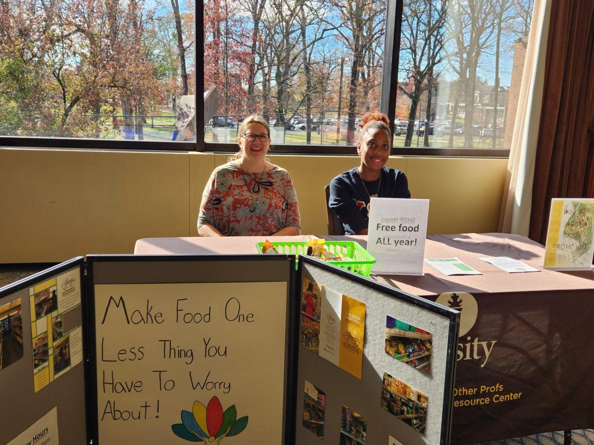 The SHOP Coordinator Becky Foster and student intern Leilanie Hinton sit at The SHOPS' resource table during the Student Hunger on Campus Town Hall Meeting and Resource Fair. - Photo / Editor-in-Chief Berry Andres