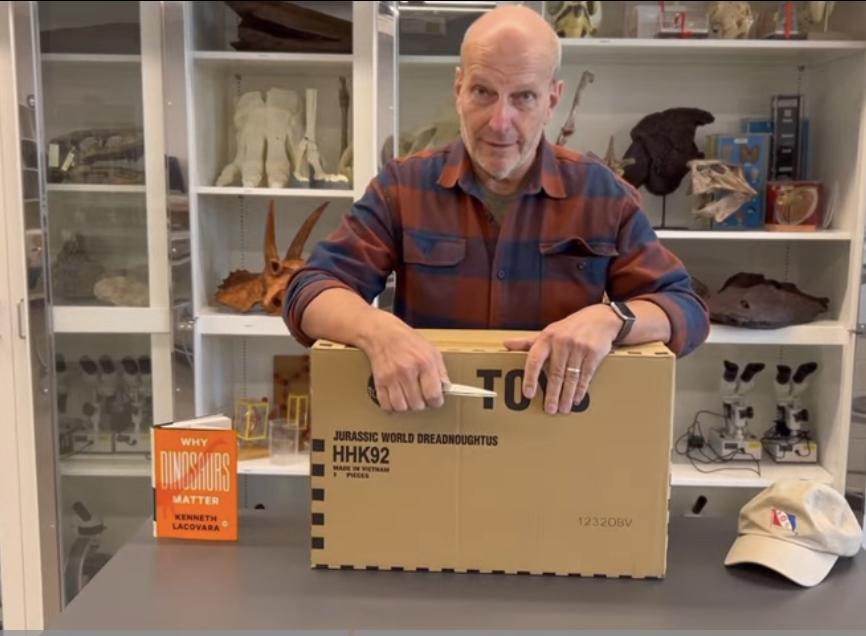 Kenneth Lacovara unboxes Dreadnoughtus dinosaur toy. - Photo / Kenneth Lacovara's Youtube video